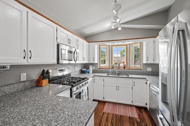 10751 Kumquat St NW, Coon Rapids, MN 55448 - kitchen featuring stainless steel appliances, a sink, lofted ceiling, dark wood finished floors, and white cabinetry