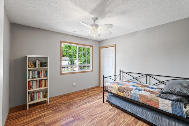10751 Kumquat St NW, Coon Rapids, MN 55448 - bedroom with wood finished floors, a textured ceiling, and ceiling fan