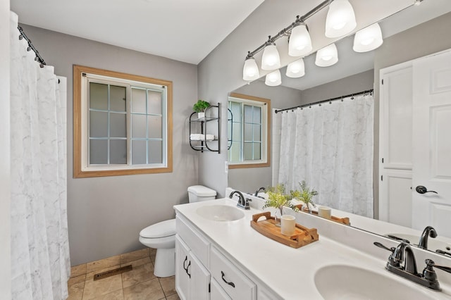 10751 Kumquat St NW, Coon Rapids, MN 55448 - bathroom with double vanity, toilet, tile patterned floors, and a shower with shower curtain