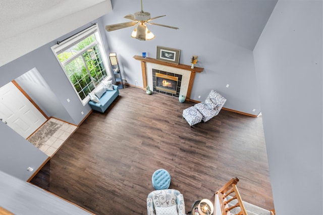7954 Timber Lake Dr, Eden Prairie, MN 55347 - living area with wood finished floors, ceiling fan, a tile fireplace, and high vaulted ceiling