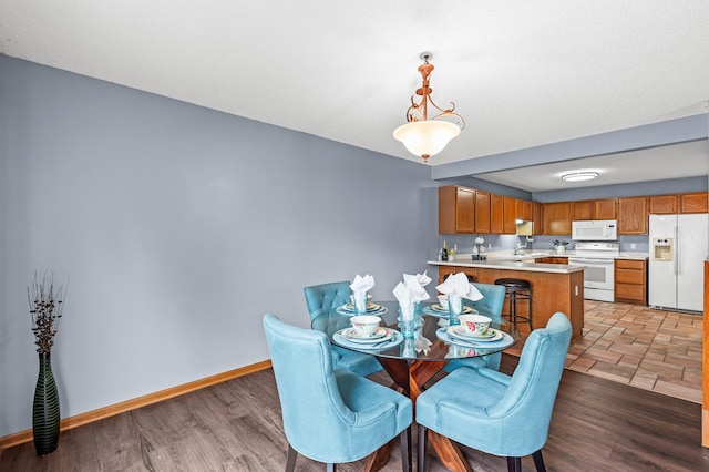 7954 Timber Lake Dr, Eden Prairie, MN 55347 - dining area featuring baseboards and light wood-style flooring