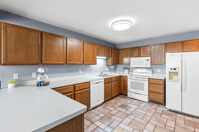 7954 Timber Lake Dr, Eden Prairie, MN 55347 - kitchen with white appliances, light countertops, stone finish flooring, and brown cabinetry