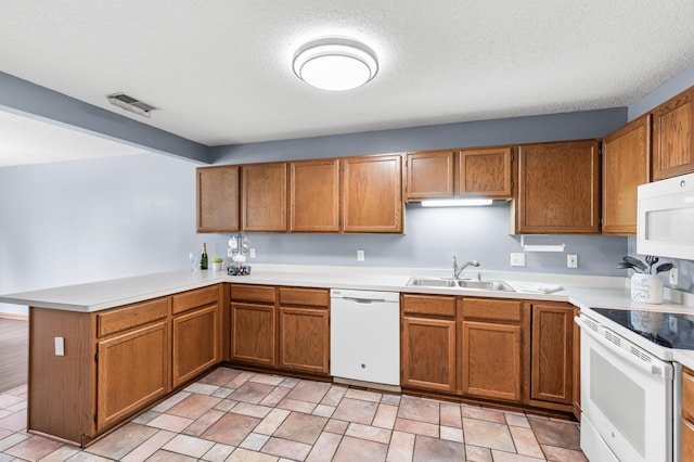 7954 Timber Lake Dr, Eden Prairie, MN 55347 - kitchen featuring white appliances, a peninsula, brown cabinetry, light countertops, and a textured ceiling