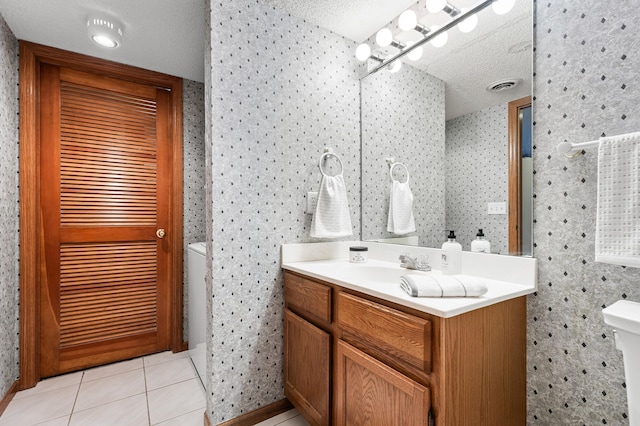 7954 Timber Lake Dr, Eden Prairie, MN 55347 - bathroom featuring vanity, wallpapered walls, tile patterned floors, and a textured ceiling