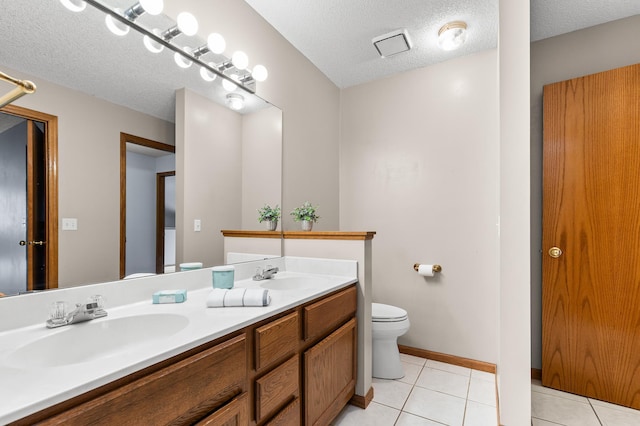7954 Timber Lake Dr, Eden Prairie, MN 55347 - full bath with double vanity, tile patterned flooring, and a textured ceiling