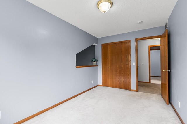 7954 Timber Lake Dr, Eden Prairie, MN 55347 - unfurnished bedroom with carpet flooring, a closet, and a textured ceiling