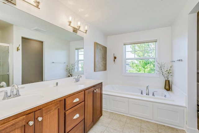full bathroom featuring a bath, a shower stall, tile patterned floors, and double vanity