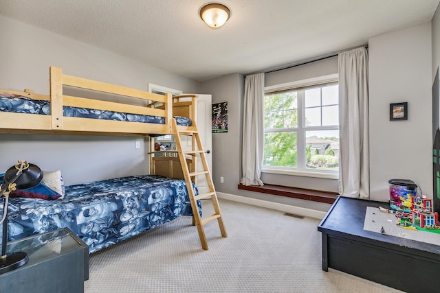 bedroom with carpet floors and baseboards