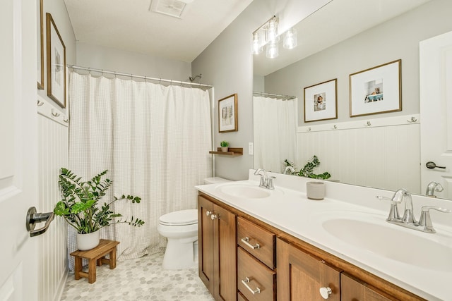 bathroom featuring toilet, double vanity, tile patterned flooring, and a shower with curtain