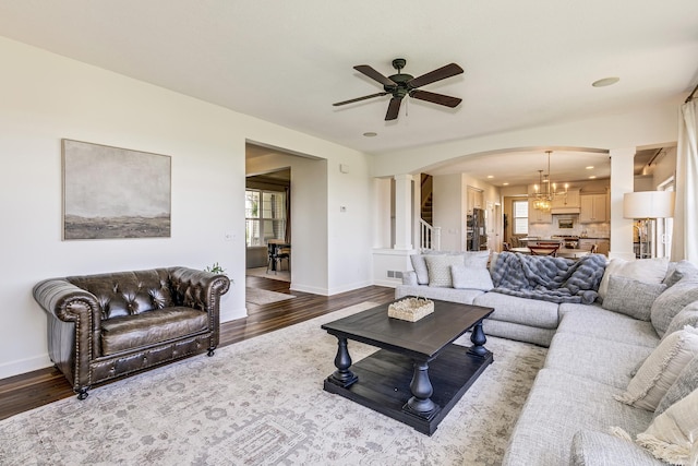 living room with ornate columns, wood finished floors, ceiling fan, a chandelier, and recessed lighting