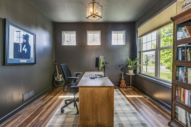 office with a textured ceiling, dark wood finished floors, a chandelier, and baseboards