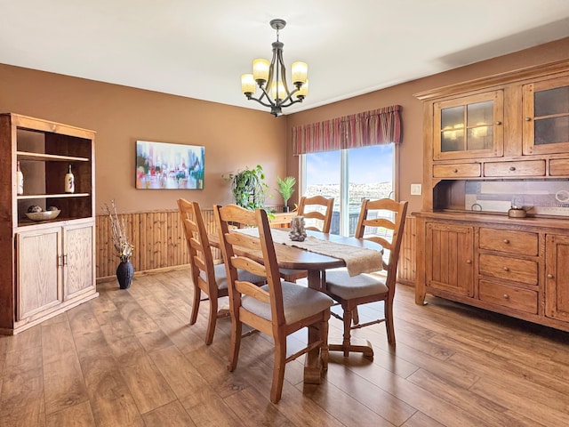 2216 County Road 15, Russell, MN 56169 - dining space with a chandelier, light wood-type flooring, and wainscoting