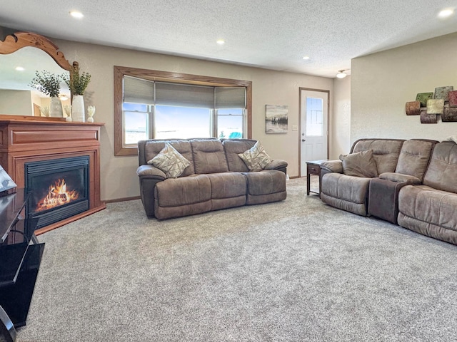 2216 County Road 15, Russell, MN 56169 - carpeted living area with recessed lighting, a glass covered fireplace, and a textured ceiling