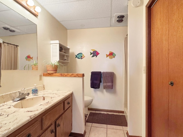 2216 County Road 15, Russell, MN 56169 - bathroom featuring a drop ceiling, tile patterned floors, curtained shower, vanity, and toilet