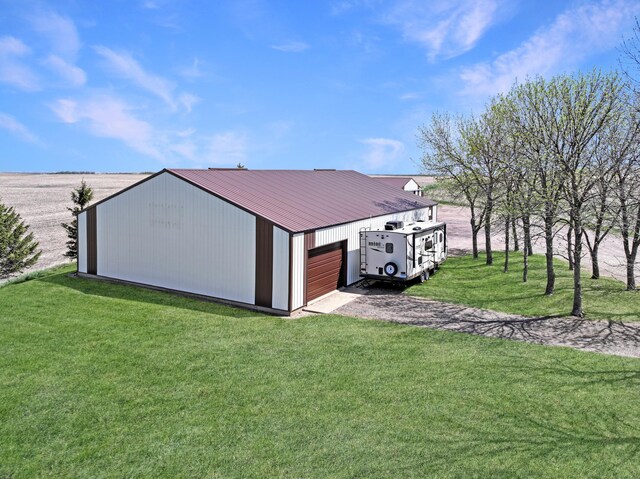 2216 County Road 15, Russell, MN 56169 - view of pole building with a lawn, a garage, and driveway