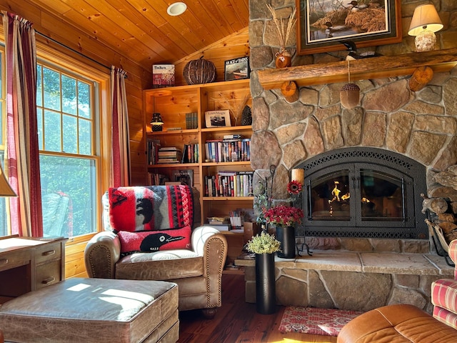 10115 Island Lake Rd, Solon Springs, WI 54873 - living area with vaulted ceiling, wood finished floors, a fireplace, wood ceiling, and wood walls