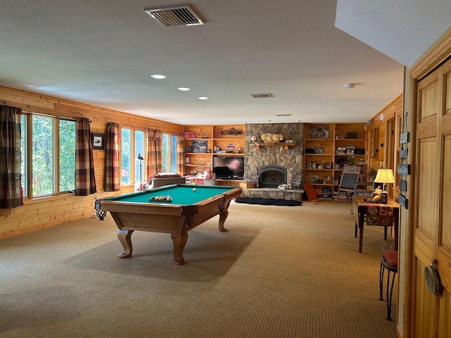 10115 Island Lake Rd, Solon Springs, WI 54873 - rec room featuring carpet, wooden walls, pool table, a stone fireplace, and a textured ceiling