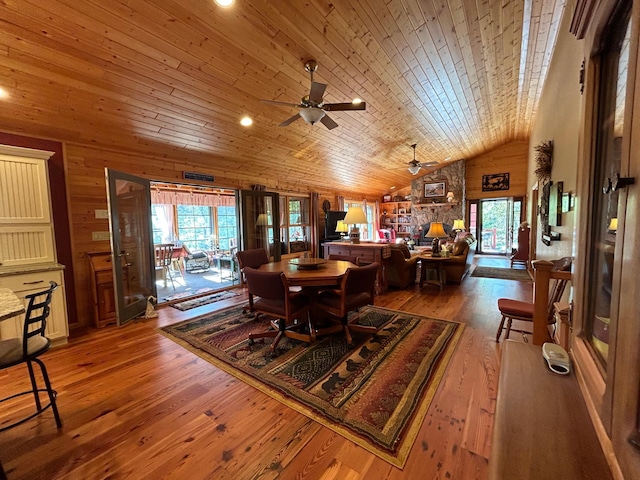 10115 Island Lake Rd, Solon Springs, WI 54873 - dining room featuring plenty of natural light, wooden walls, lofted ceiling, a ceiling fan, and hardwood / wood-style flooring