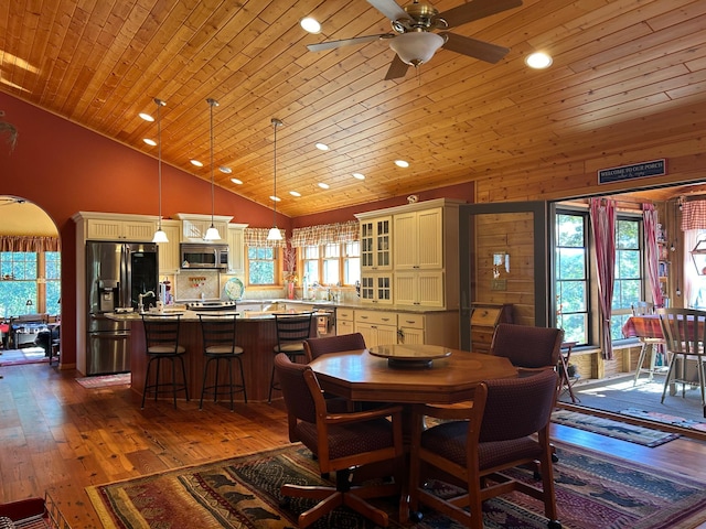 10115 Island Lake Rd, Solon Springs, WI 54873 - dining room with ceiling fan, recessed lighting, healthy amount of natural light, arched walkways, and dark wood-type flooring