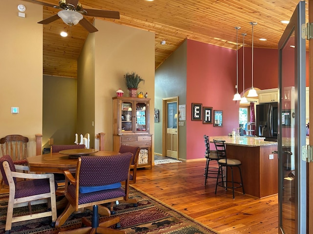 10115 Island Lake Rd, Solon Springs, WI 54873 - dining space with a ceiling fan, light wood-style flooring, wood ceiling, high vaulted ceiling, and baseboards
