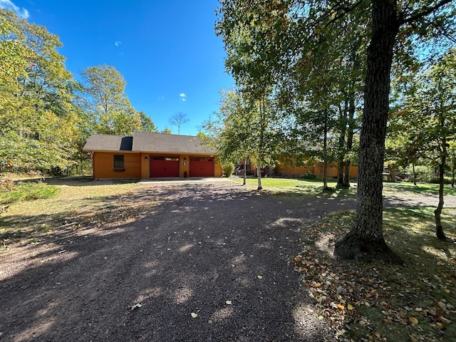10115 Island Lake Rd, Solon Springs, WI 54873 - view of side of home with an attached garage and dirt driveway