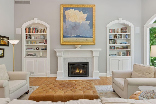 490 Old Long Lake Rd, Orono, MN 55391 - living room featuring wood finished floors, a premium fireplace, and built in shelves