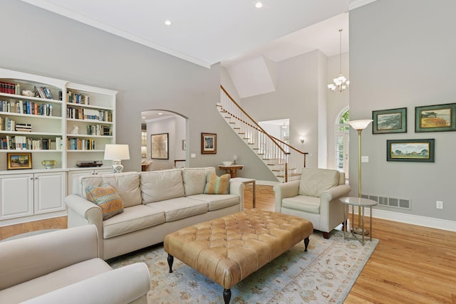 490 Old Long Lake Rd, Orono, MN 55391 - living room with stairs, light wood-style floors, baseboards, arched walkways, and recessed lighting