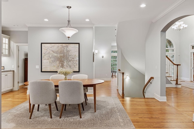 490 Old Long Lake Rd, Orono, MN 55391 - dining area featuring arched walkways, light wood finished floors, crown molding, recessed lighting, and baseboards