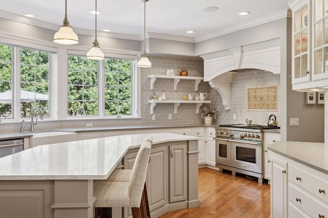 490 Old Long Lake Rd, Orono, MN 55391 - kitchen featuring double oven range, backsplash, a kitchen island, glass insert cabinets, and light wood-type flooring