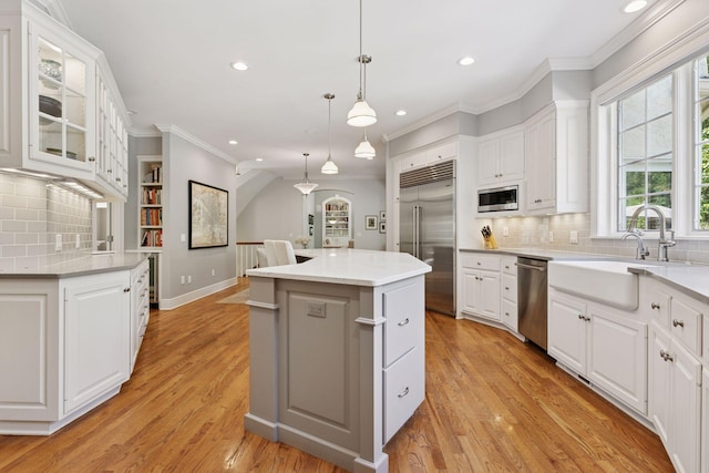 490 Old Long Lake Rd, Orono, MN 55391 - kitchen with built in appliances, recessed lighting, a sink, a center island, and ornamental molding