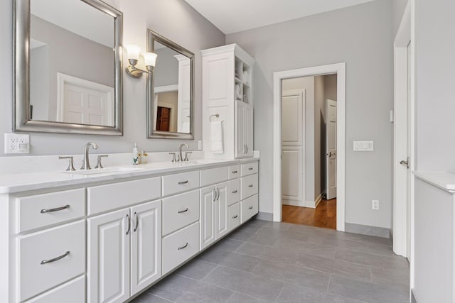 490 Old Long Lake Rd, Orono, MN 55391 - bathroom with double vanity, tile patterned flooring, and baseboards