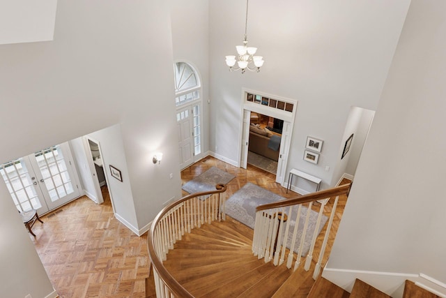 490 Old Long Lake Rd, Orono, MN 55391 - stairway with a high ceiling, french doors, baseboards, a chandelier, and healthy amount of natural light