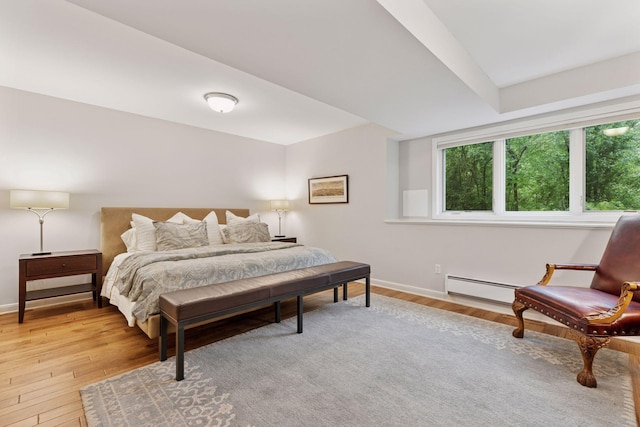 490 Old Long Lake Rd, Orono, MN 55391 - bedroom with a baseboard heating unit, light wood-style floors, and baseboards