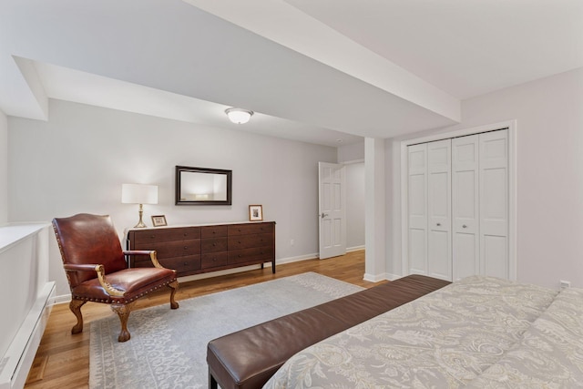 490 Old Long Lake Rd, Orono, MN 55391 - bedroom featuring wood finished floors, baseboards, a closet, and a baseboard radiator