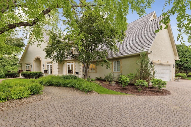 490 Old Long Lake Rd, Orono, MN 55391 - view of front of house featuring stucco siding, decorative driveway, and a garage