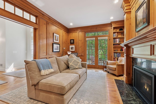 490 Old Long Lake Rd, Orono, MN 55391 - living area with recessed lighting, a fireplace, french doors, light wood-type flooring, and wooden walls