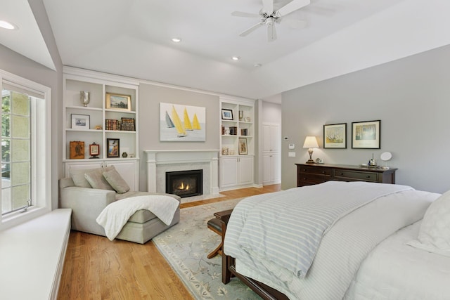 490 Old Long Lake Rd, Orono, MN 55391 - bedroom featuring wood finished floors, a high end fireplace, recessed lighting, and ceiling fan