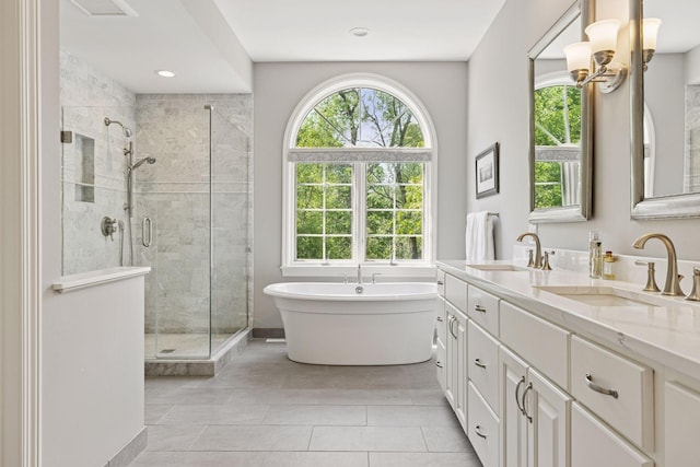 490 Old Long Lake Rd, Orono, MN 55391 - bathroom with a stall shower, a freestanding bath, tile patterned floors, double vanity, and a chandelier