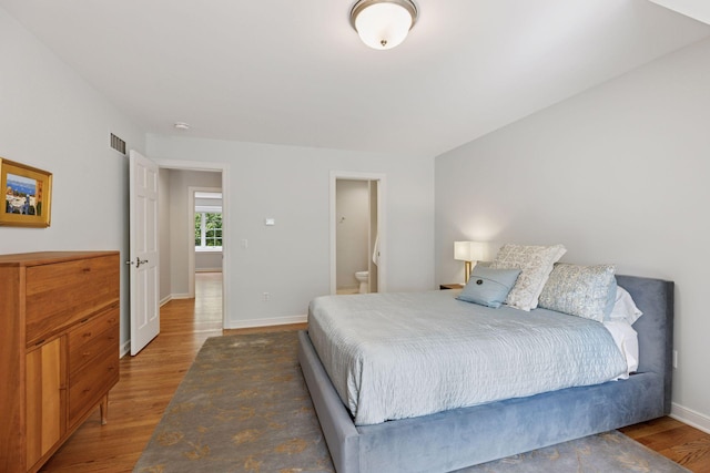 490 Old Long Lake Rd, Orono, MN 55391 - bedroom featuring wood finished floors and ensuite bath