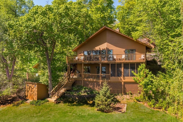 8744 Interlachen Rd, Lake Shore, MN 56468 - back of property with a yard, stairway, a wooden deck, and a sunroom