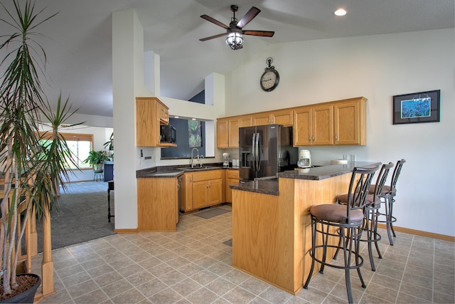910 Shady Ridge Ln, Braham, MN 55006 - kitchen with black appliances, a sink, a peninsula, high vaulted ceiling, and baseboards