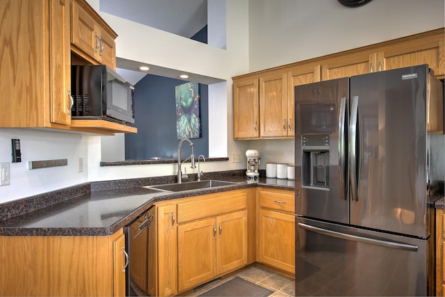 910 Shady Ridge Ln, Braham, MN 55006 - kitchen with stainless steel fridge with ice dispenser, a sink, black microwave, and brown cabinetry