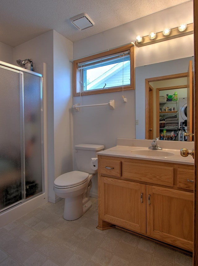 910 Shady Ridge Ln, Braham, MN 55006 - full bath with a stall shower, toilet, vanity, a textured ceiling, and tile patterned floors
