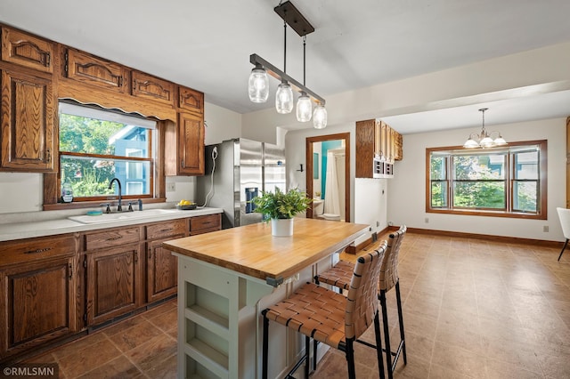 920 2nd St S, Stillwater, MN 55082 - kitchen featuring stainless steel fridge with ice dispenser, wood counters, plenty of natural light, and a kitchen bar