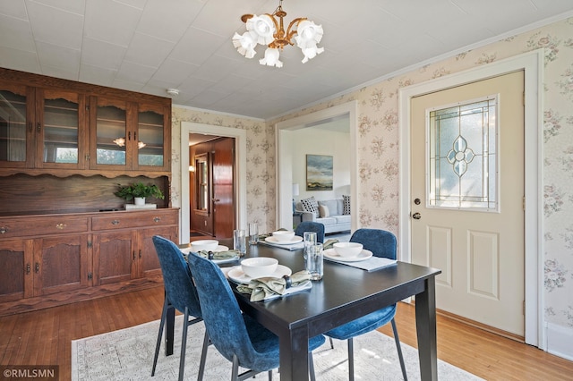 920 2nd St S, Stillwater, MN 55082 - dining room featuring a chandelier, wallpapered walls, light wood-style floors, and ornamental molding