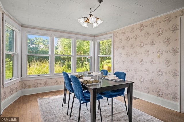 920 2nd St S, Stillwater, MN 55082 - dining area with hardwood / wood-style flooring, a chandelier, wallpapered walls, and crown molding