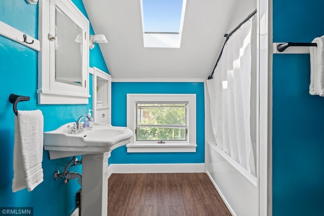 920 2nd St S, Stillwater, MN 55082 - bathroom with vaulted ceiling, wood finished floors, a skylight, and shower / bath combination with curtain
