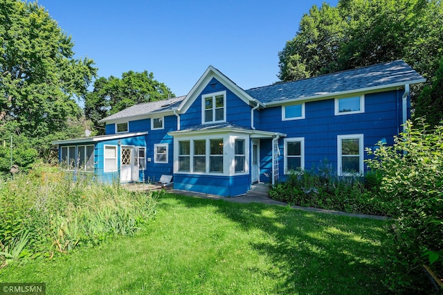 920 2nd St S, Stillwater, MN 55082 - rear view of house with a sunroom and a lawn