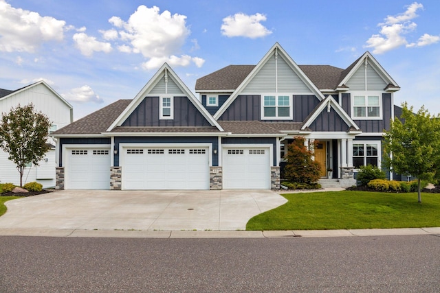62 Rapp Farm Blvd, North Oaks, MN 55127 - craftsman house featuring board and batten siding, a front yard, driveway, stone siding, and a garage