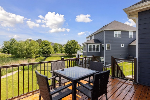 62 Rapp Farm Blvd, North Oaks, MN 55127 - deck with outdoor dining area and a lawn